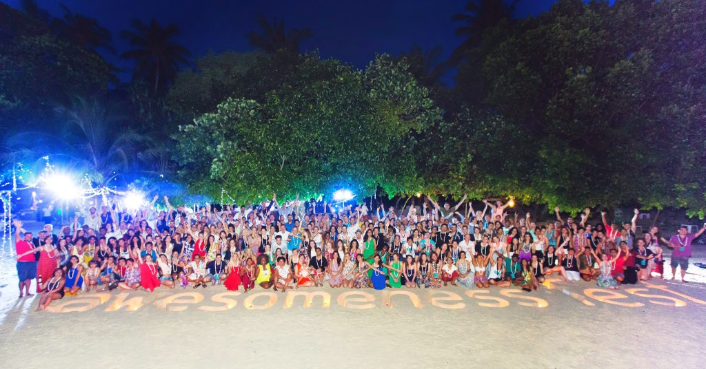 The whole Tribe on the beach of a private island ready for the closing event on the last day.